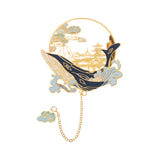 Marque-page en métal doré représentant une vague, une baleine et un palais oriental, design poétique