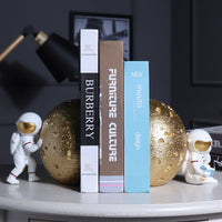 Serre-livres design avec astronautes et planètes dorées en résine