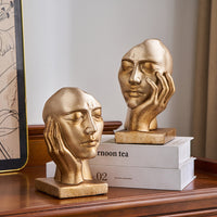 Serre-livre en résine dorée représentant un visage rêveur, intitulé Le Songe d’Or.