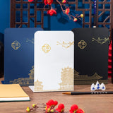 Serre livre en métal avec temples dorés et motifs asiatiques sur fond bleu, blanc et noir